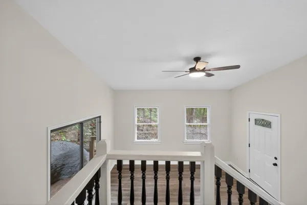 a bedroom with a bed and a ceiling fan