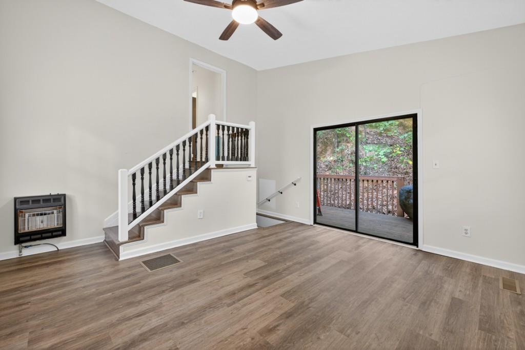 256 Robin Hood Ln N East Fairmount, GA 30139 - Photo 10 of 52 a view of an empty room with wooden floor and a window