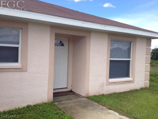 4440 28th Street Southwest Lehigh Acres, FL 33973 - Photo 2 of 4 a view of front door of a house