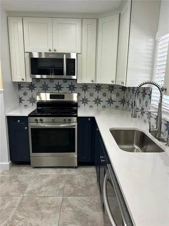 a kitchen with a sink stove and microwave