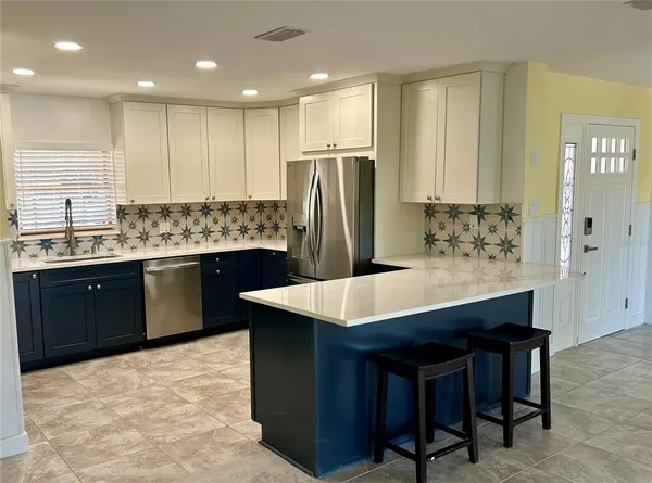 a kitchen with stainless steel appliances a sink stove and refrigerator