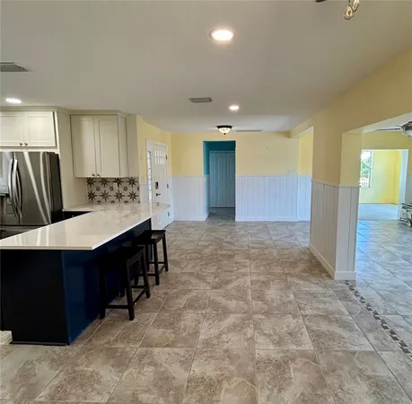 a kitchen with stainless steel appliances a sink cabinets and wooden floor