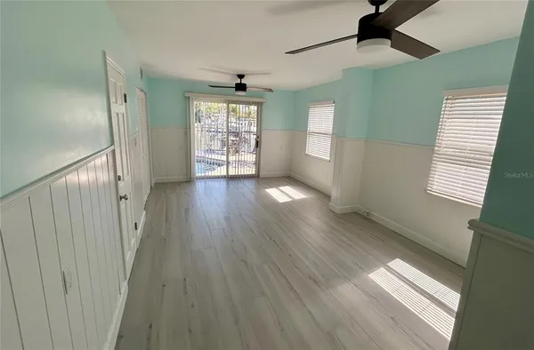 wooden floor in an empty room with a window