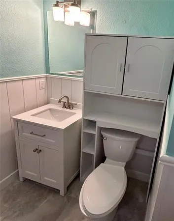 a white toilet sitting next to a bathroom sink