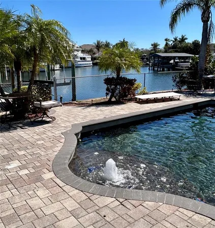 a view of a swimming pool with a yard