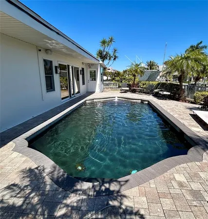 a swimming pool with outdoor seating and yard