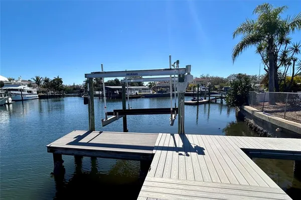 a view of roof deck with outdoor seating and lake view