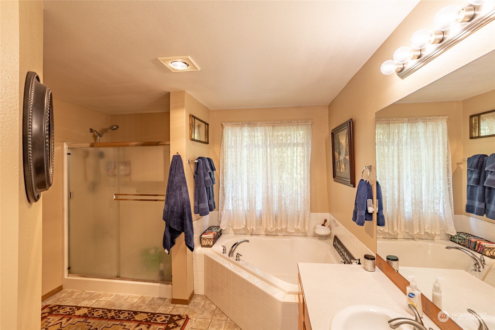 526 Haywire Road Napavine, WA 98532 - Photo 30 of 40 a bathroom with a tub sink and mirror