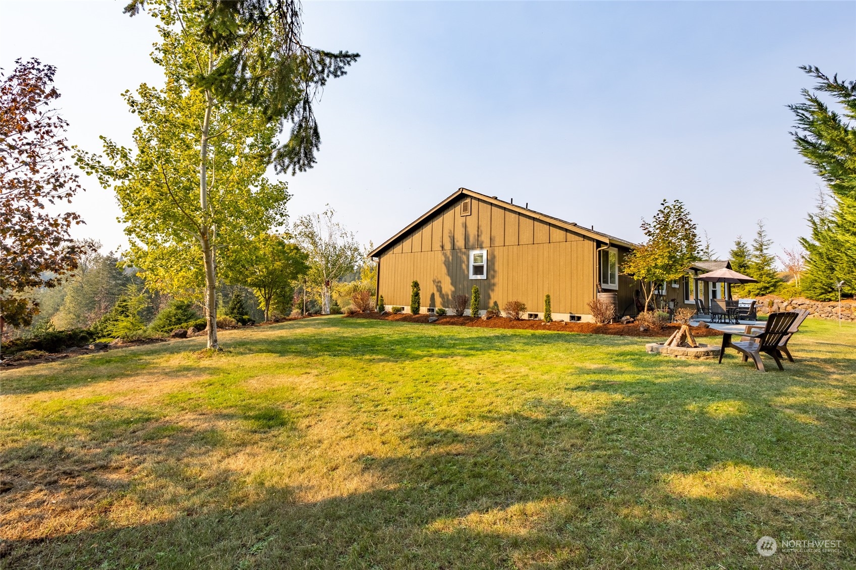 526 Haywire Road Napavine, WA 98532 - Photo 6 of 40 a view of a swimming pool with an outdoor space and seating area
