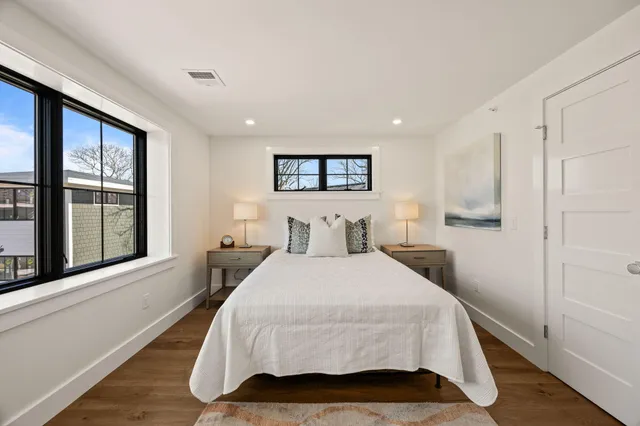 a bedroom with a bed and a large window