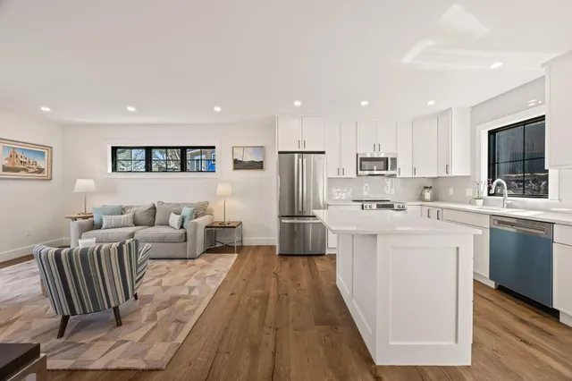 a large white kitchen with stainless steel appliances