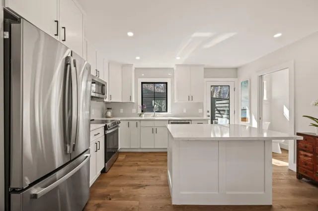 a kitchen with refrigerator cabinets and furniture