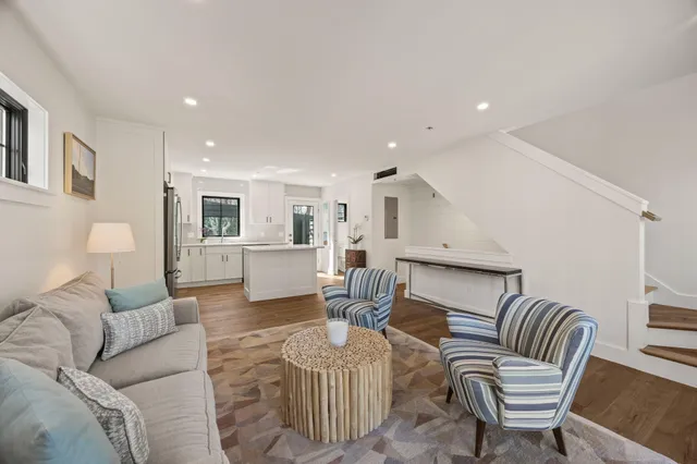 a living room with furniture or kitchen view and a wooden floor