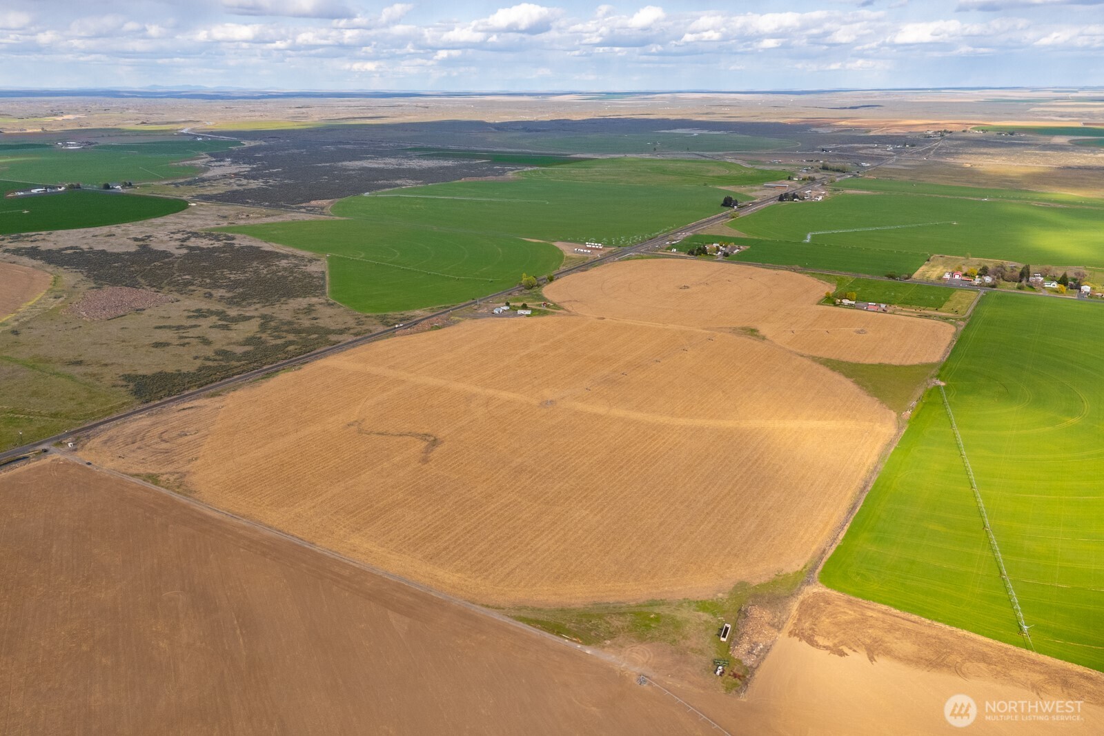 10701 12 Road Northeast Moses Lake, WA 98837 - Photo 33 of 33 a view of a big yard with an empty space and outdoor seating