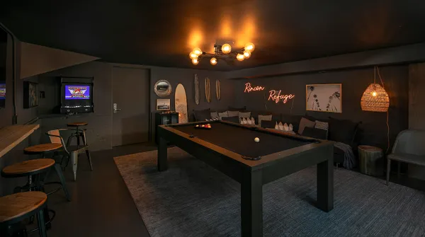 a room with furniture a chandelier and pool table