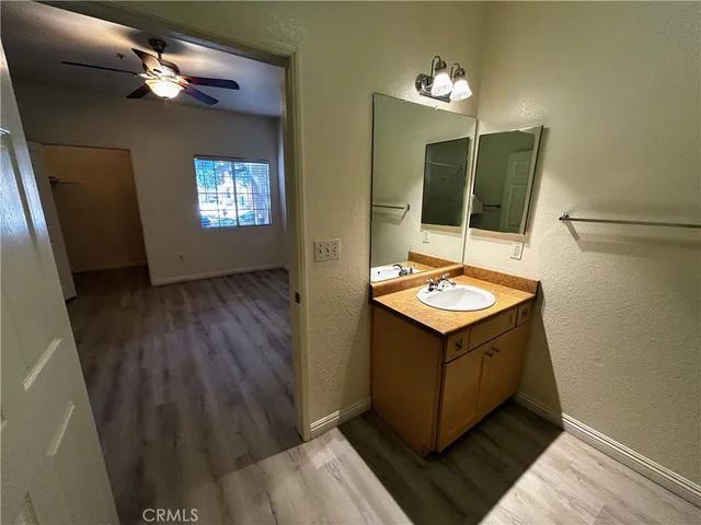 a bathroom with a sink a light fixture and a mirror