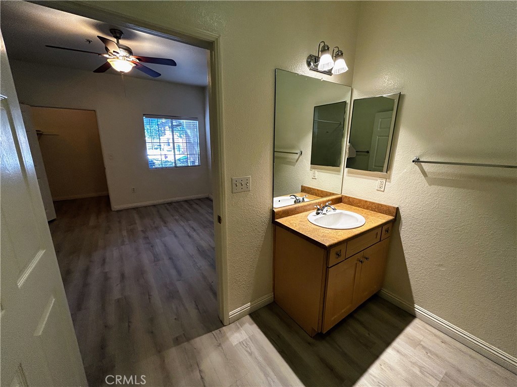 24909 Madison, Unit 111 Murrieta, CA 92562 - Photo 14 of 25 a bathroom with a sink a light fixture and a mirror