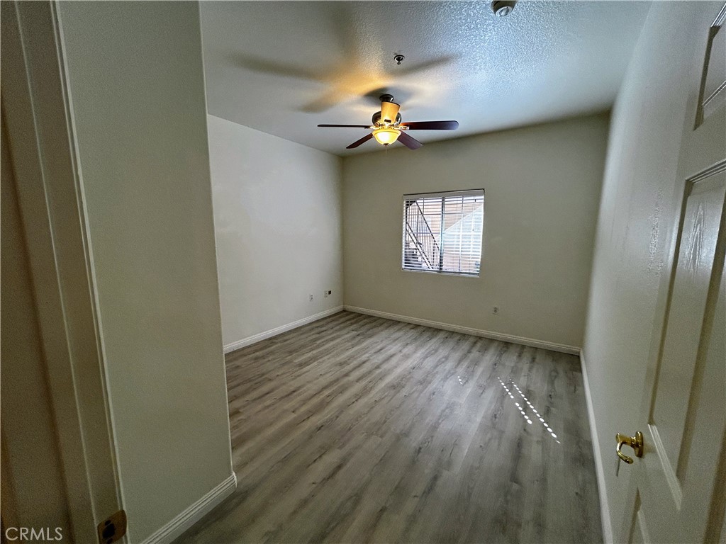 24909 Madison, Unit 111 Murrieta, CA 92562 - Photo 15 of 25 wooden floor in an empty room with a window