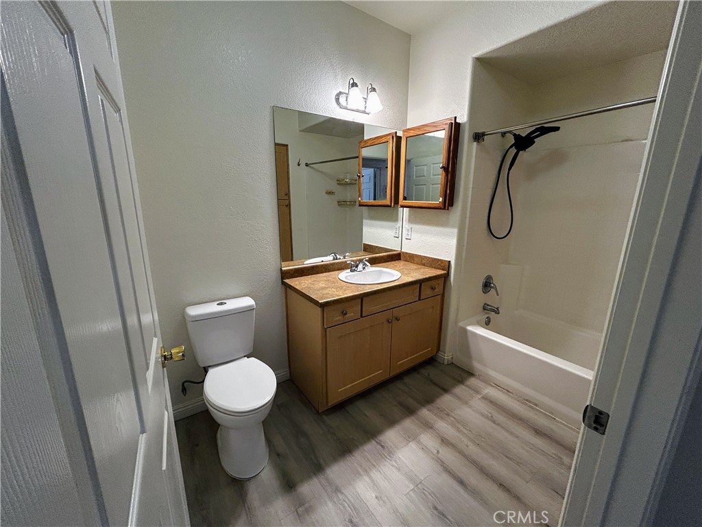 24909 Madison, Unit 111 Murrieta, CA 92562 - Photo 18 of 25 a bathroom with a granite countertop sink toilet and shower