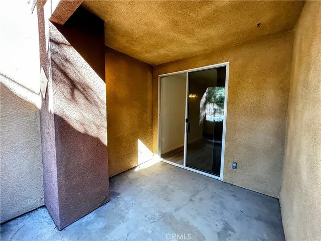 a view of a hallway with wooden shelves