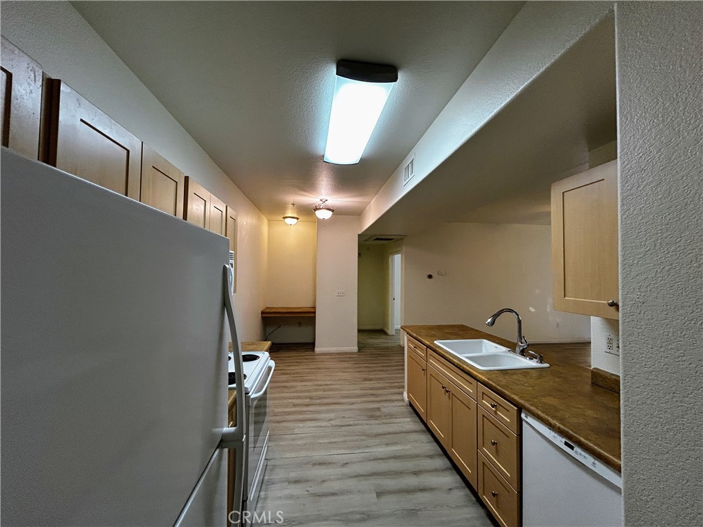24909 Madison, Unit 111 Murrieta, CA 92562 - Photo 9 of 25 a kitchen with stainless steel appliances a refrigerator and a stove