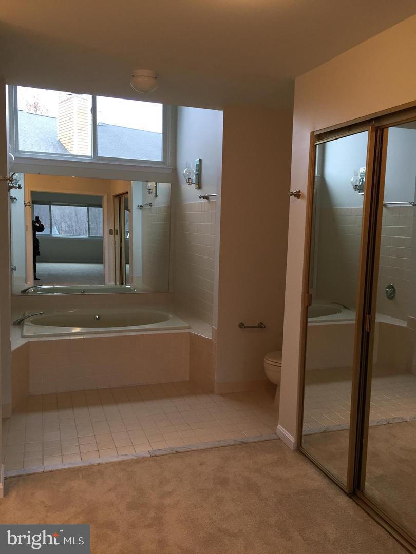 11242 Harbor Court, Unit 1242 Reston, VA 20191 - Photo 7 of 8 a bathroom with a tub and shower