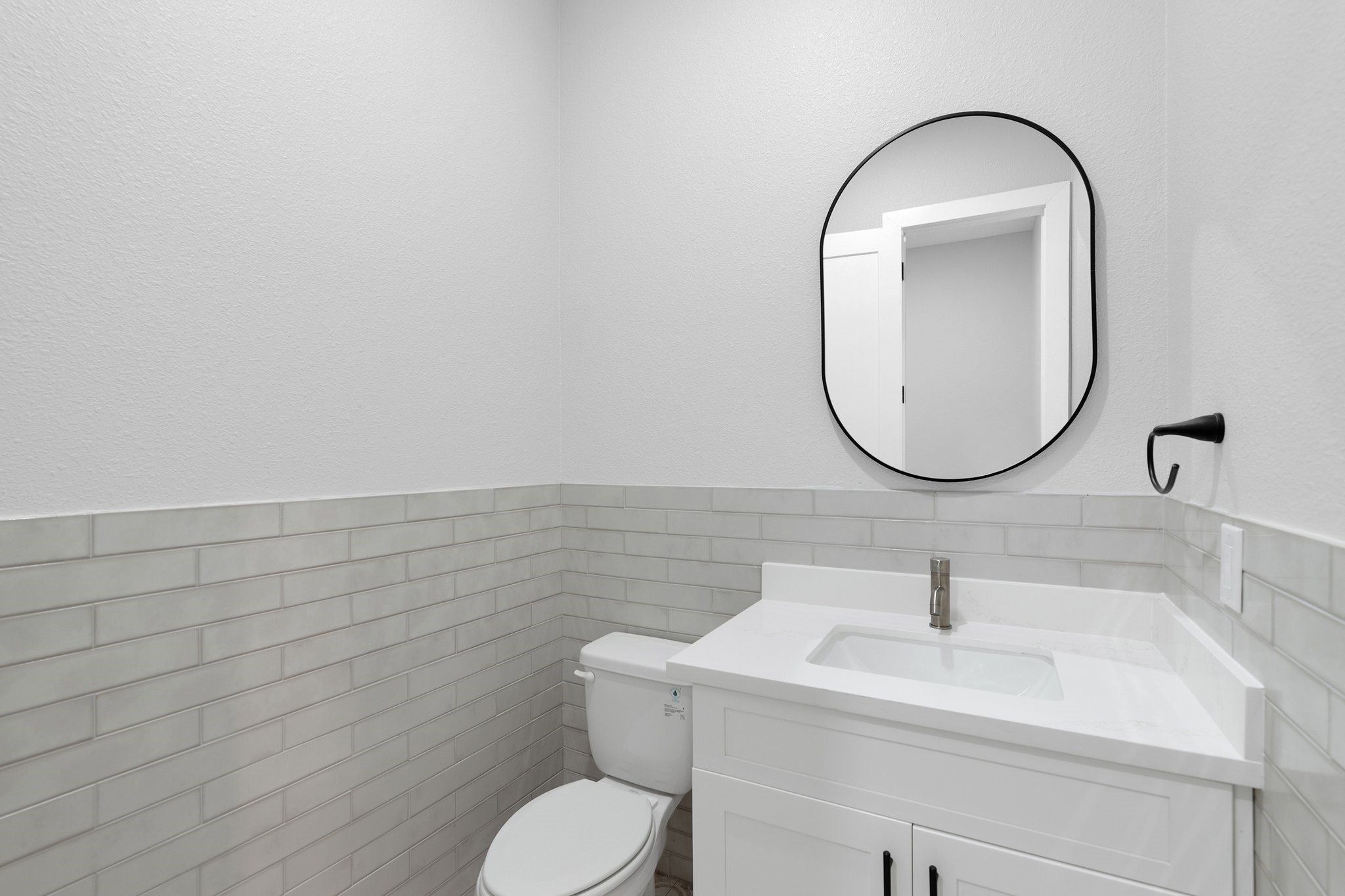 519 Chuckwagon Trail Angleton, TX 77515 - Photo 22 of 34 a bathroom with a toilet a sink and a mirror