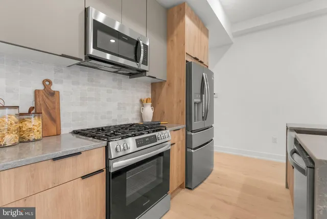 a kitchen with granite countertop a stove and a microwave