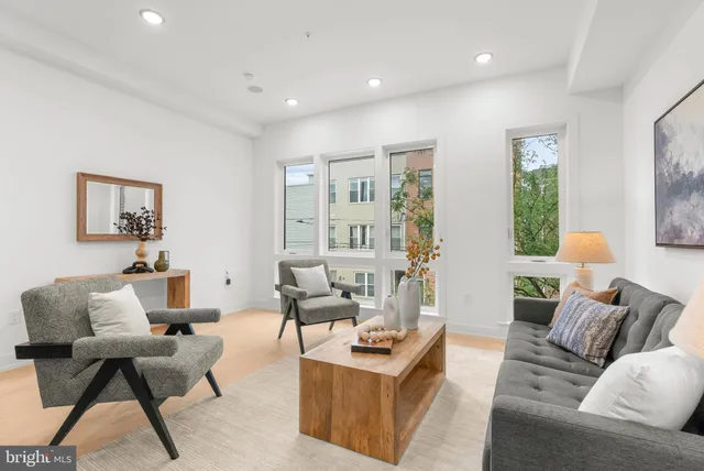 a living room with furniture and a large window