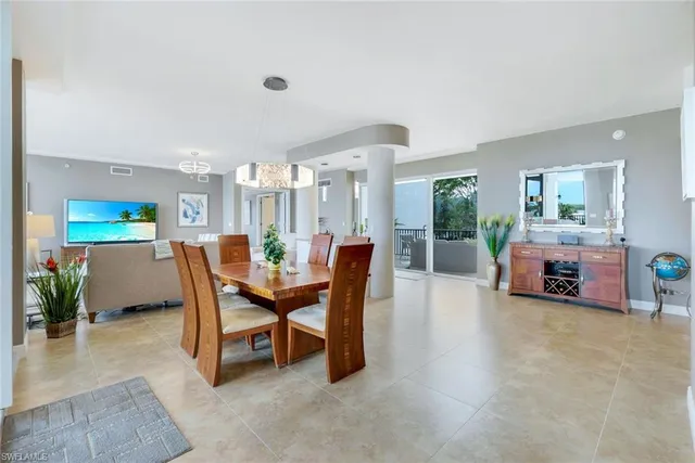 a living room with furniture and a dining table