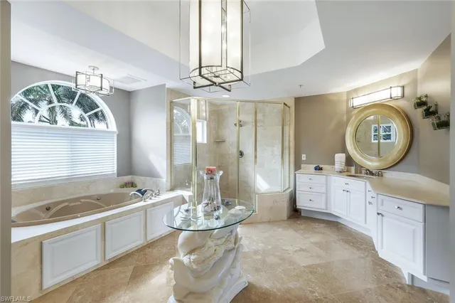 a large spacious bathroom with a granite countertop tub sink and mirror