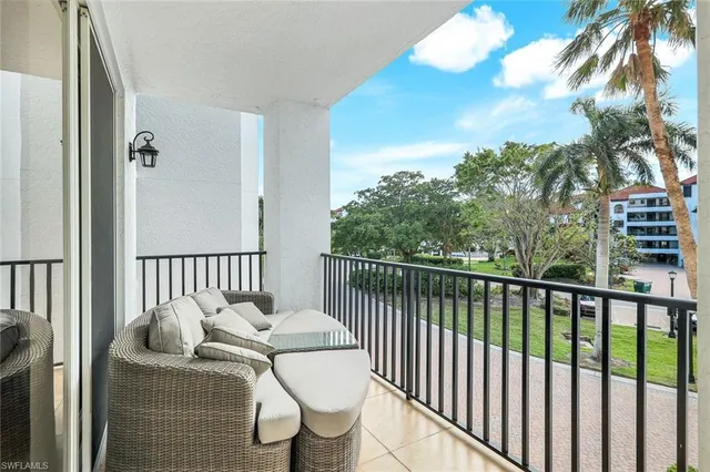 a balcony with table and chairs