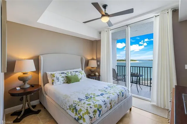 a bedroom with a bed mirror and window