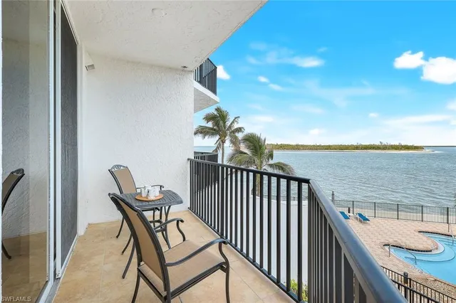 a view of a balcony with chair and wooden floor