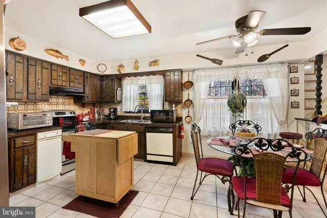 a living room with furniture a lamp and a large window