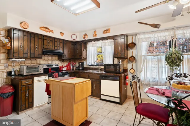 a bathroom with a sink double vanity granite tub shower and a mirror