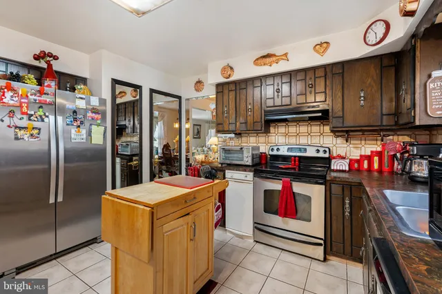 a bathroom with a double vanity sink mirror and cabinet