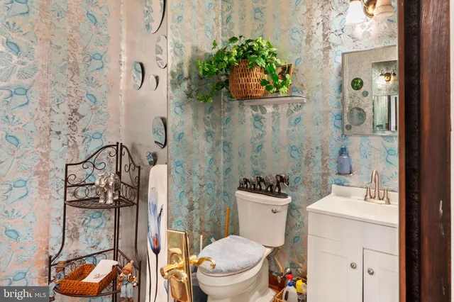 a bathroom with a sink a toilet and a mirror