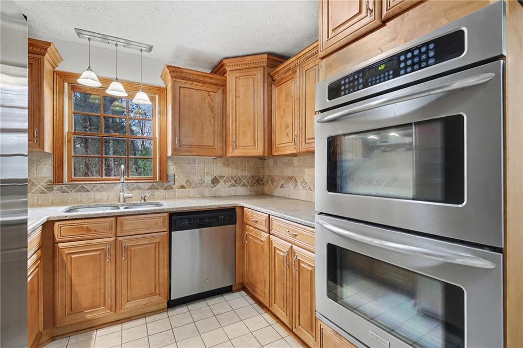 2981 Wilsons Crossing Court Decatur, GA 30033 - Photo 5 of 24 a kitchen with granite countertop a stove sink and cabinets