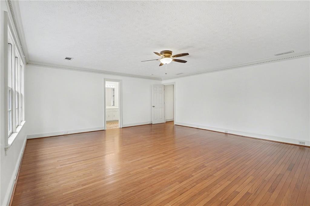 2981 Wilsons Crossing Court Decatur, GA 30033 - Photo 9 of 24 an empty room with wooden floor and chandelier fan