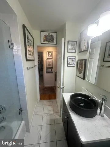 a bedroom with a bed and painting on the wall