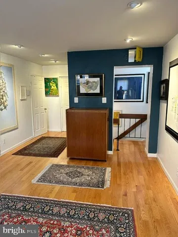 a living room with dining table and a fireplace