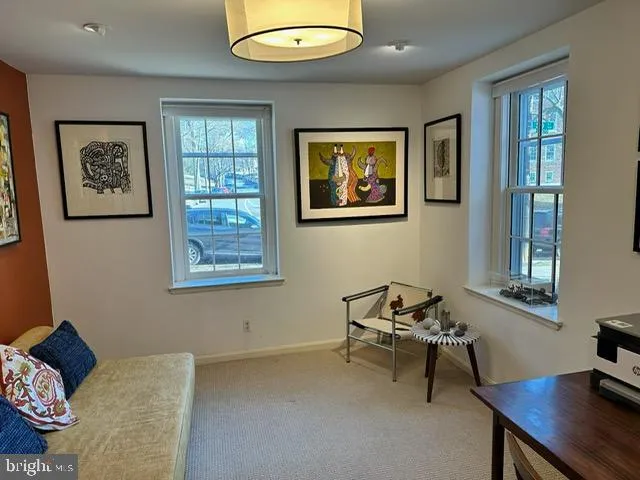 a room with furniture pool table and windows