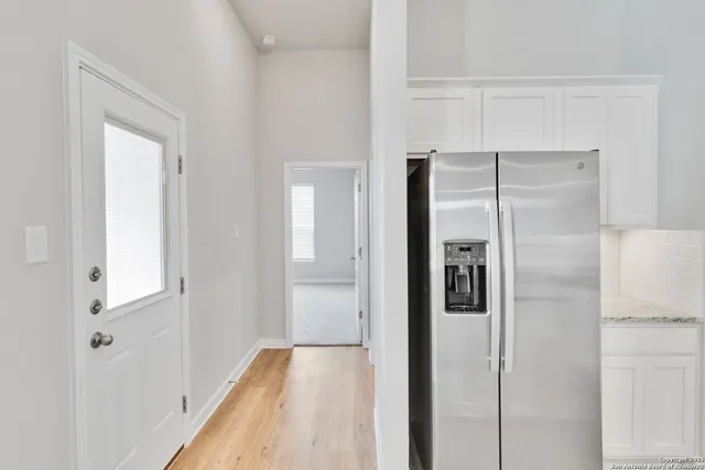 a view of hallway with wooden floor
