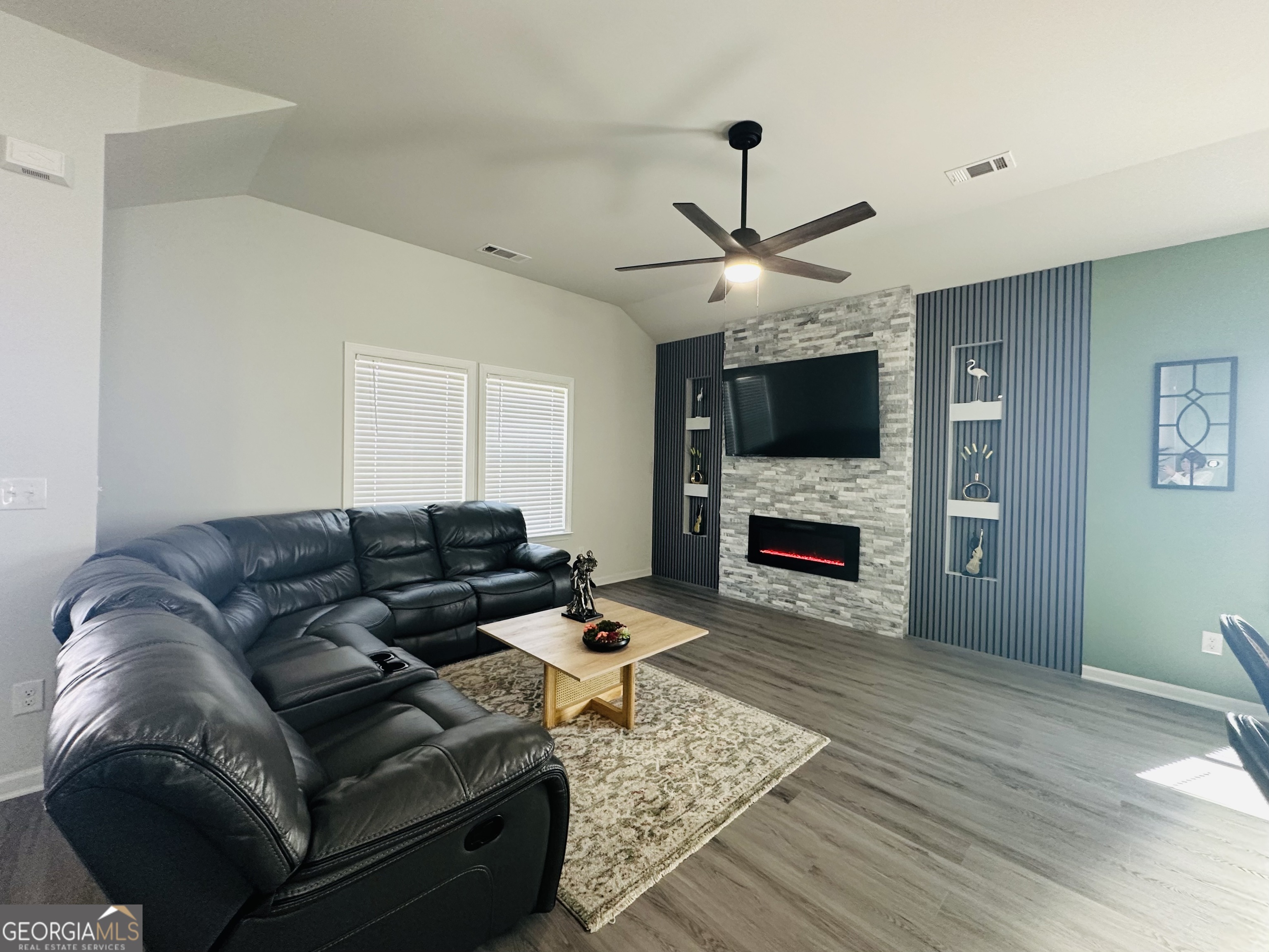 604 Georgian Walk Byron, GA 31008 - Photo 6 of 15 a living room with furniture a fireplace and a flat screen tv