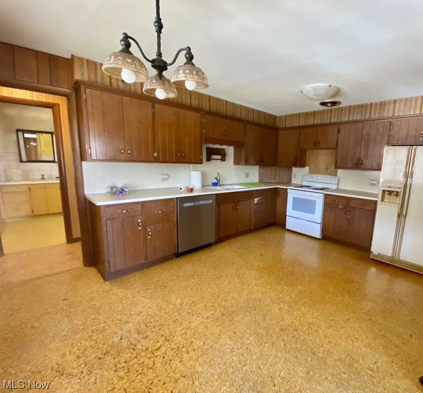 9520 Stone Road Litchfield, OH 44253 - Photo 12 of 22 Kitchen with white appliances, a notable chandelier, hanging light fixtures, and sink