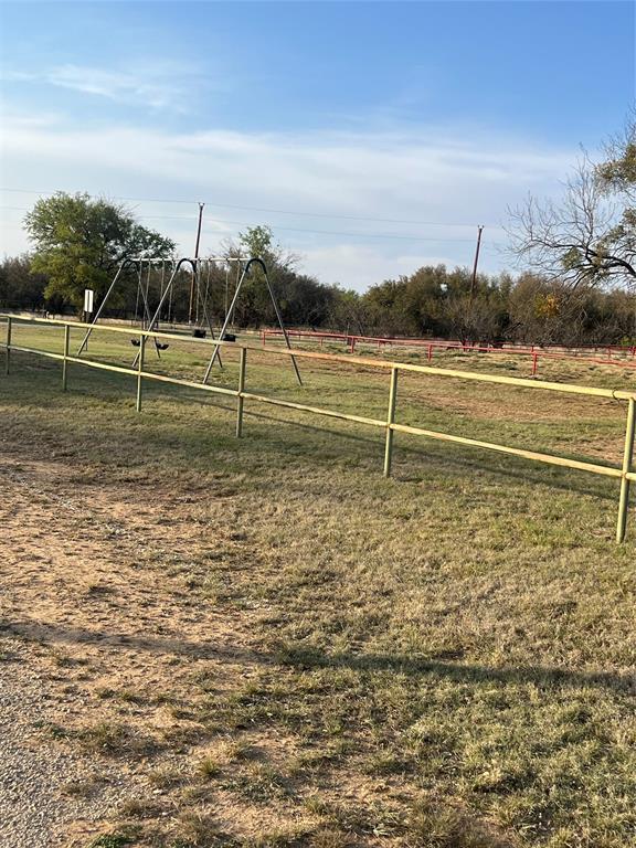 311 North Lakeside Circle May, TX 76857 - Photo 4 of 7 a view of a green field with wooden fence