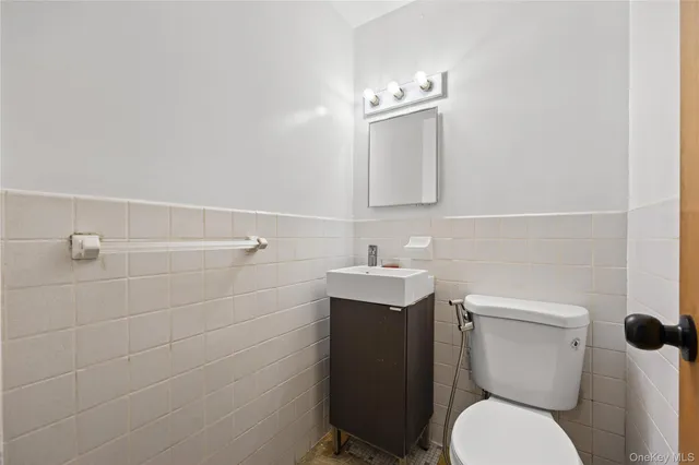 a bathroom with a toilet sink and mirror