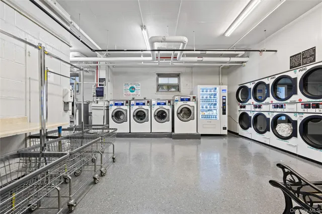 a utility room with stainless steel appliances granite countertop a stove and a sink