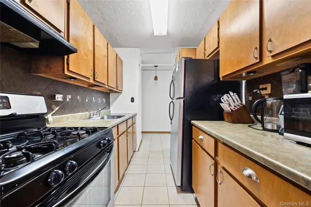 a kitchen with stainless steel appliances granite countertop a stove and a refrigerator